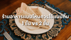 แนปกิ้นผ้าพับสวยงามวางบนจานในร้านอาหาร สื่อถึงการเลือกใช้แนปกิ้น 1 ชั้นและ 2 ชั้น